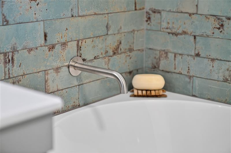Freestanding bath against handmade tiles