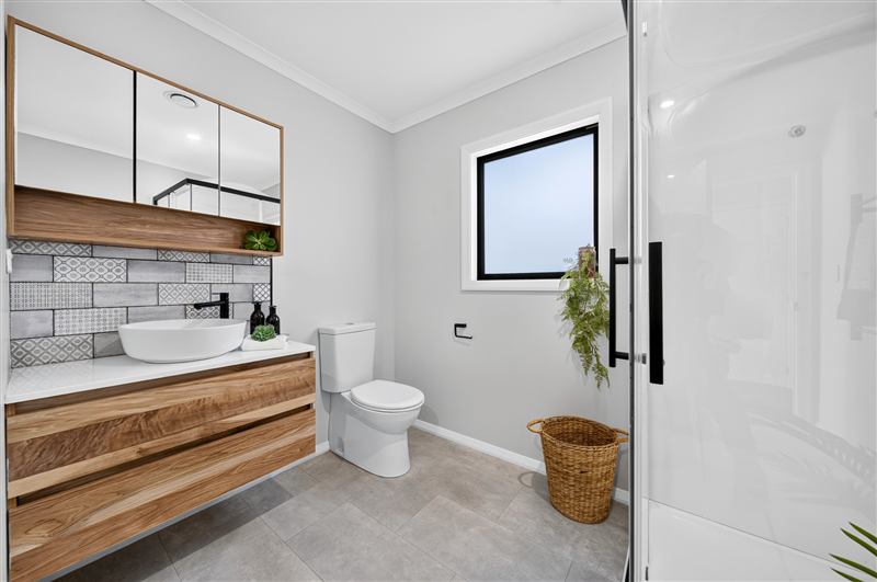 Bathroom with a timber vanity and black-framed shower