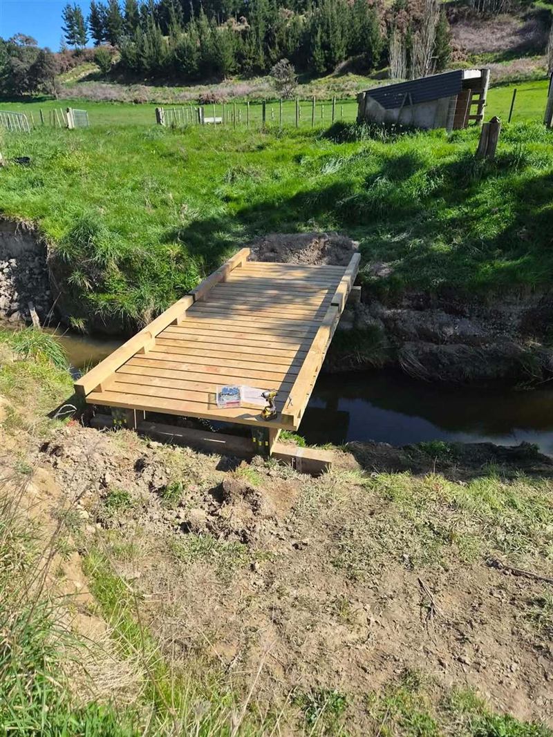 Timber farm bridge over a stream
