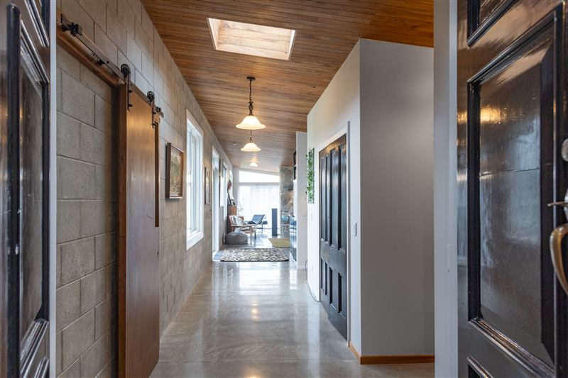 Hallway with a timber ceiling and sliding doors