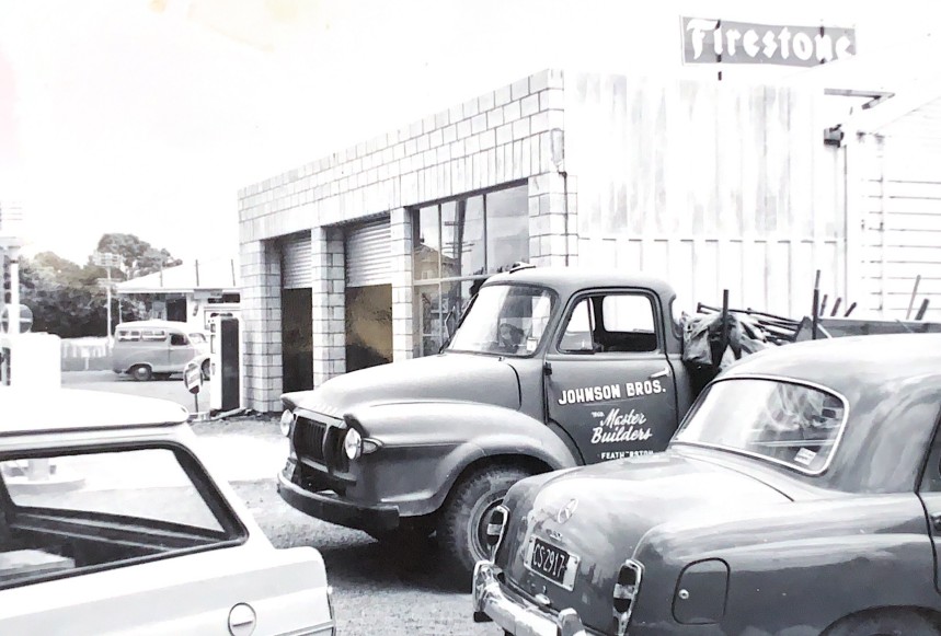An old Johnson Brothers Building work truck outside the Firestone garage